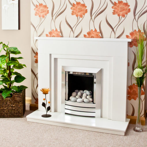 Stepped Wendle marble fireplace in a Blanco Micro marble. Shown with a full depth gas fire and pebble fuel bed